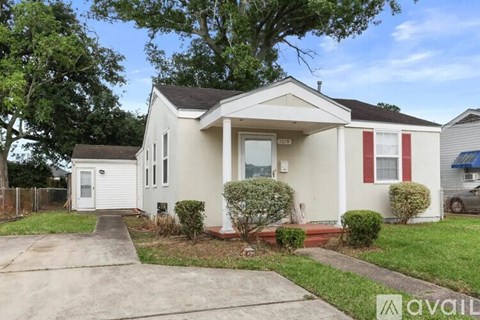 A two-story house with a white front door and red trim.