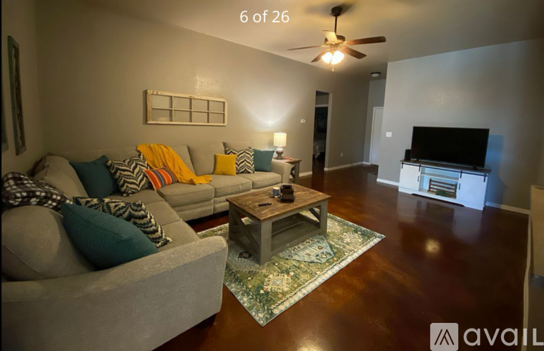 A living room with a grey couch and a coffee table.