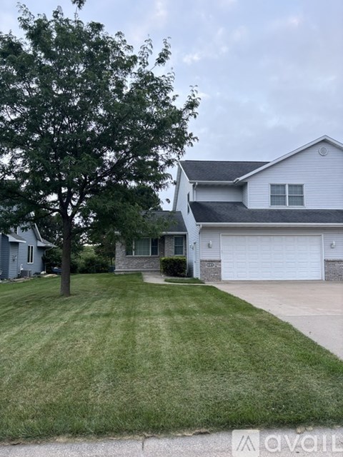 A house with a tree in front of it.