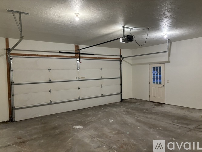 A spacious garage with a white door and a window.