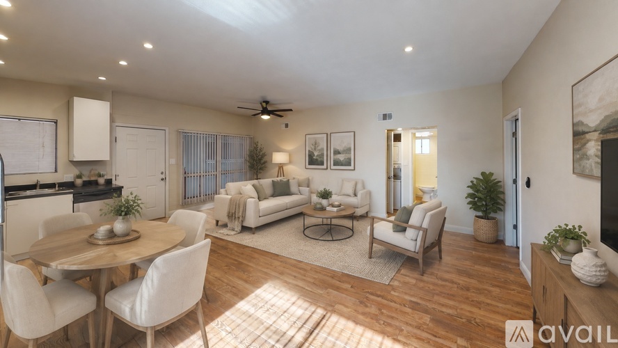 A well-lit living room with a dining table and chairs.