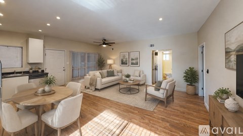 A well-lit living room with a dining table and chairs.