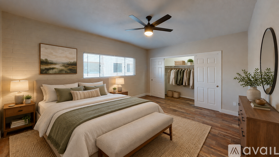 A bedroom with a large bed and a ceiling fan.
