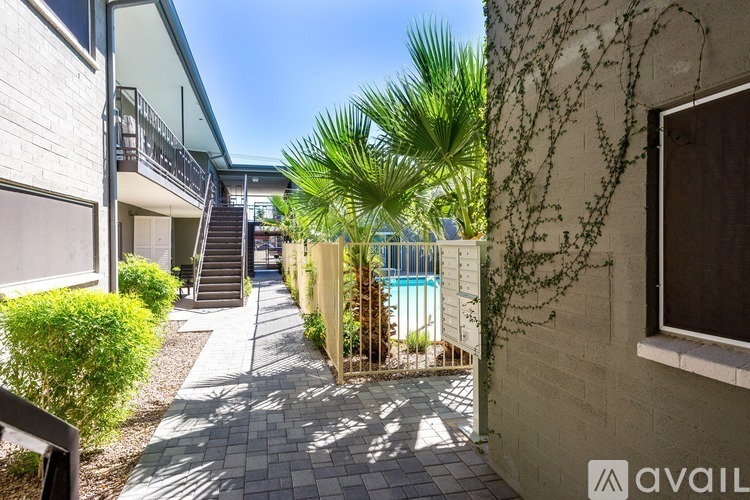 A sunny day at a residential area with a pool and a building with a balcony.