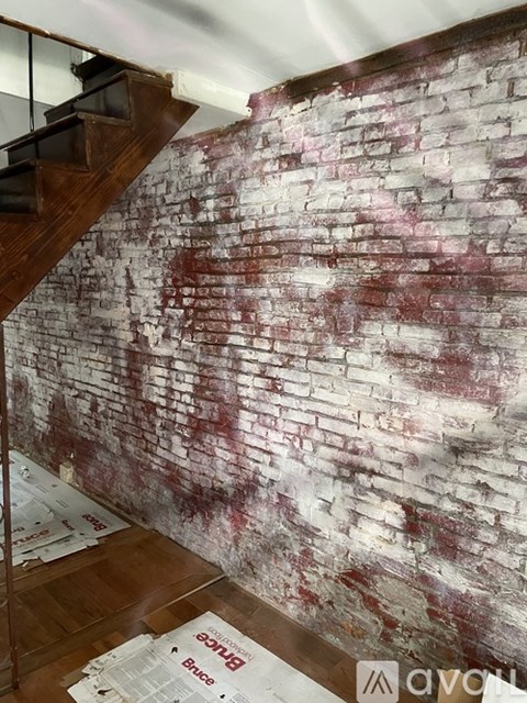A wall covered in white and red brick.