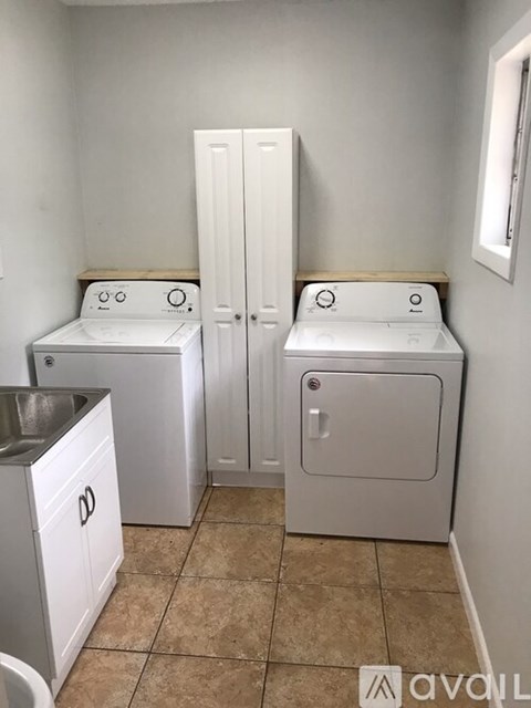 A small laundry room with a washer and dryer.