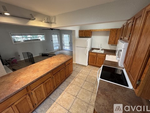 A kitchen with wooden cabinets and a countertop.