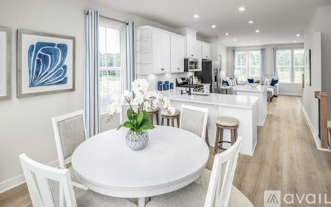 A modern kitchen with a dining table set for four.