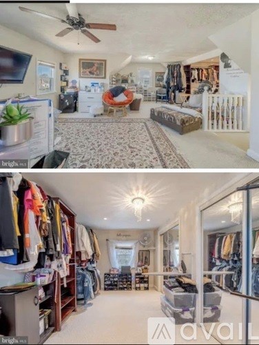 A well-lit, spacious room with a large closet and a seating area.