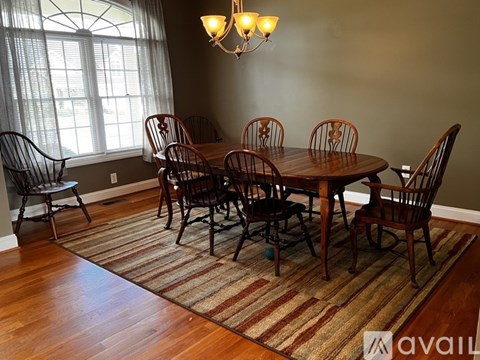 A dining room with a table set for six.