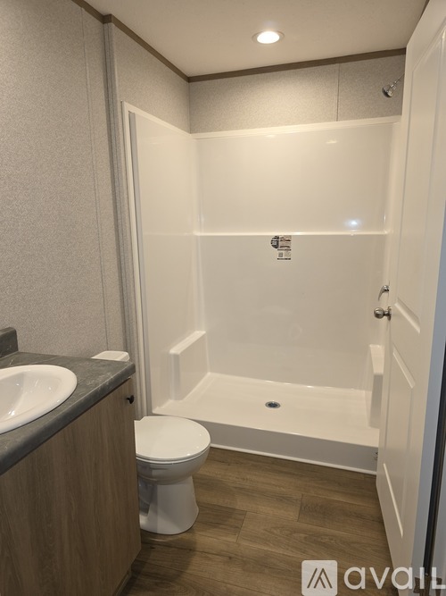 A bathroom with a toilet, sink, and bathtub.
