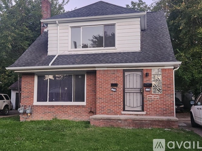A house with a brick facade and a grey roof.