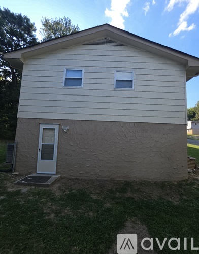A house with a white door and two windows.