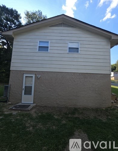 A house with a white door and two windows.