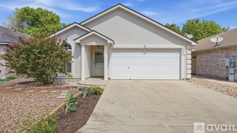 A house with a white garage door is for sale.