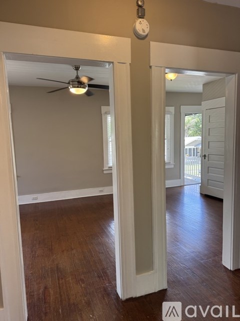 A room with a fan and a clock on the wall.