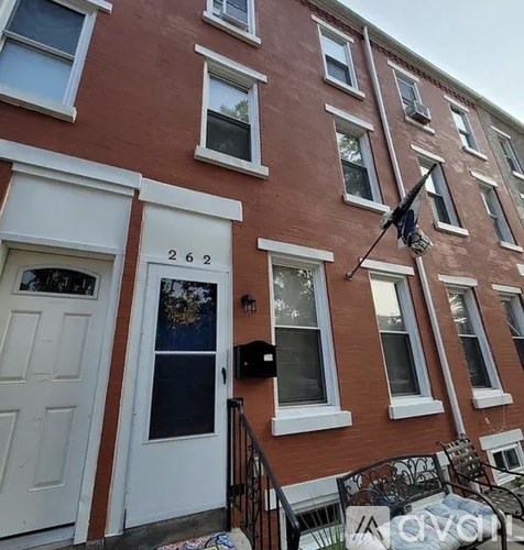 A red building with the number 262 on the door.