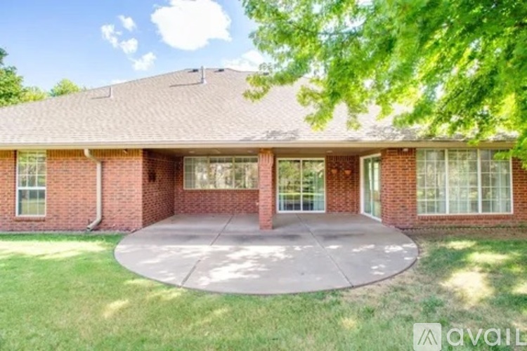 A house with a brick exterior and a large front yard.