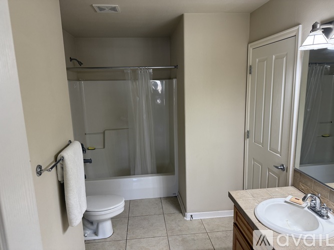 A bathroom with a toilet, sink, and shower.
