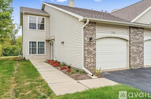 A house with a garage and a driveway in front.
