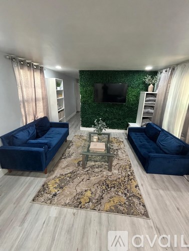 A living room with two blue sofas and a coffee table.