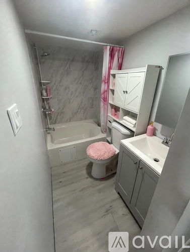 A bathroom with a tub, sink, and mirror.