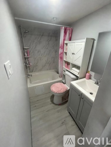A bathroom with a tub, sink, and mirror.