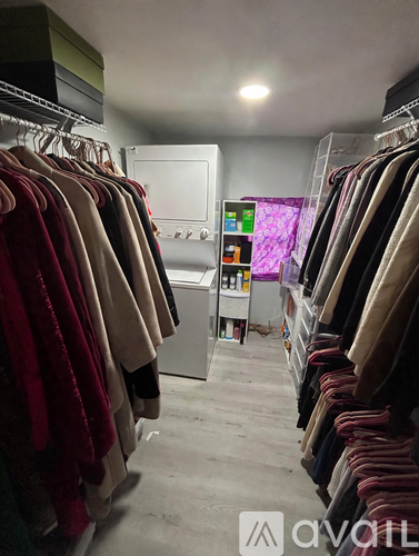 Clothes hanging on a rack in a room.