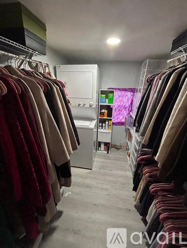 Clothes hanging on a rack in a room.