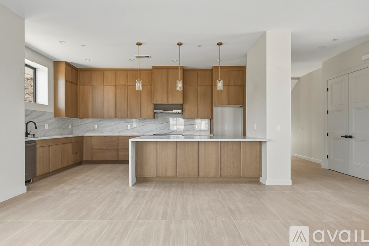 A modern kitchen with wooden cabinets and a central island.