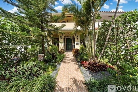 A house entrance is framed by a garden with a path leading to it.
