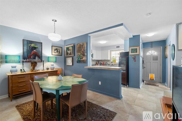 A dining room with a table and chairs.