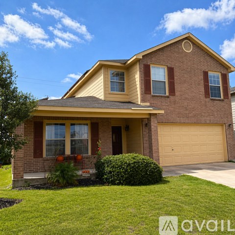 A house with a brown and beige exterior and a garage door.