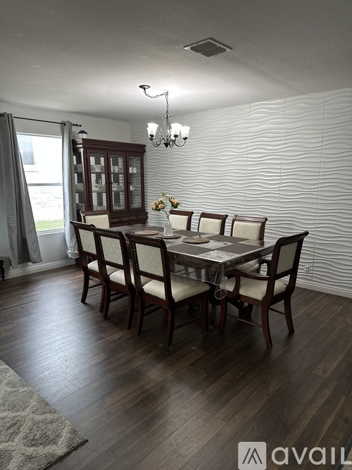 A dining room with a table set for four.