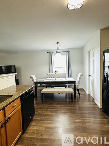A kitchen with a table and chairs in the middle of the room.