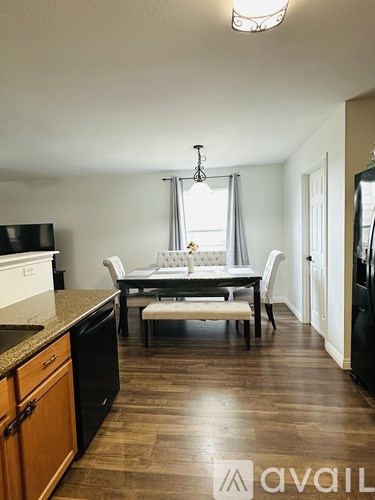 A kitchen with a table and chairs in the middle of the room.
