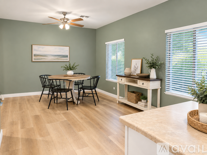 A dining room with a table and chairs.