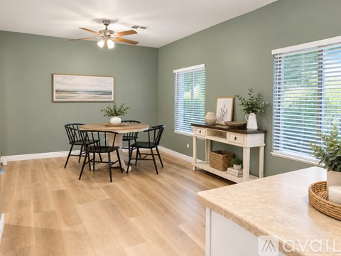 A dining room with a table and chairs.