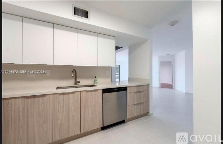 A kitchen with wooden cabinets and a white countertop.