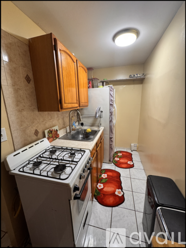 A small kitchen with a stove and a refrigerator.