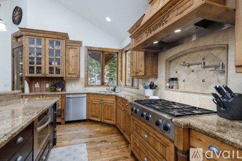 A kitchen with wooden cabinets and a granite countertop.