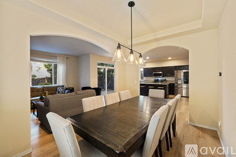 A modern dining room with a large table and chairs.