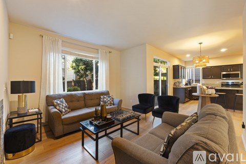 A living room with a grey couch, a black chair, and a coffee table.