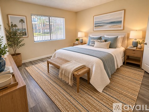 A bedroom with a large bed and a painting on the wall.