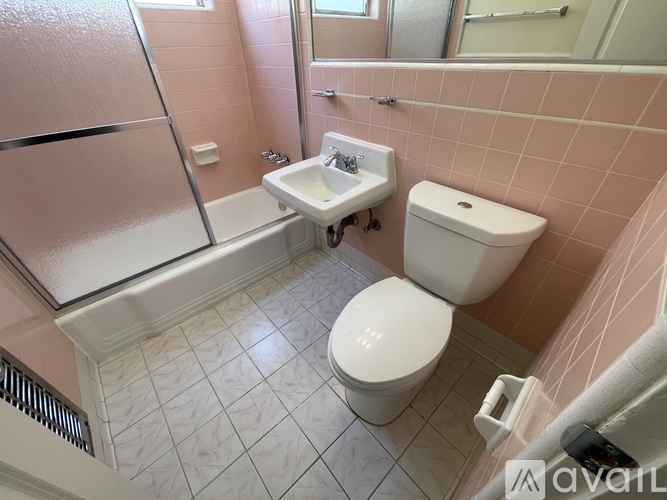 A small bathroom with a toilet, sink, and bathtub.