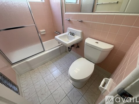 A small bathroom with a toilet, sink, and bathtub.