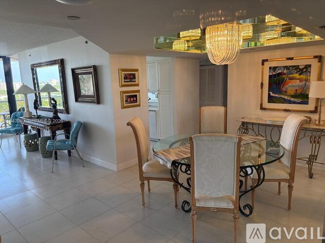 A dining room with a glass table and chairs.