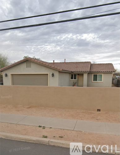 A house with a beige wall and a brown roof is shown.