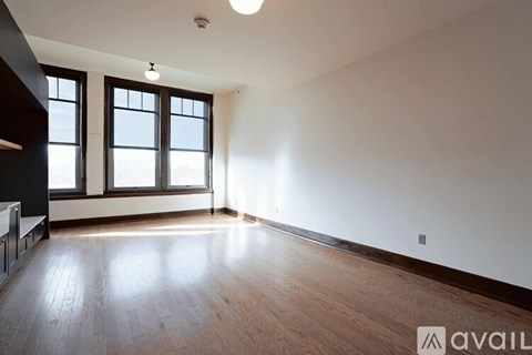 A room with wooden floors and a window.