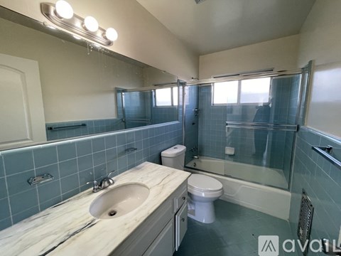 A bathroom with a sink, toilet, and bathtub.